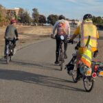 Three bicyclists riding along the Delta de Anza Trail in Pittsburg