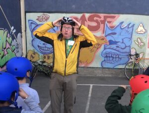 Instructor demonstrate helmet fitting.