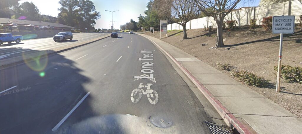 Google street view image of Lone Tree Way in Antioch looking northbound from James Donlon Blvd - "bicycles may use sidewalk" sign along the sidewalk and shared lane bike stencils on the roadway
